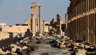 (FILES) This file photo taken on March 31, 2016 shows the remains of the destroyed Arc du Triomphe lie at the end of the the Great Colonnade in the ancient city of Palmyra in central Syria.  AFP / JOSEPH EID
