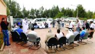 Officials and farmers during an awareness programme about artificial liquid pollination of date palm.