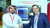 Sheikh Hamad bin Abdullah Al Thani (left), Director of Enterprise Sales, Vodafone Qatar, with Dimitris Flokos, Zelitron’s Business Development Director at the Vodafone booth at QITCOM Conference and Exhibition, yesterday.  Pic: Baher Amin / The Peninsula