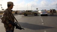 Forces loyal to Libya's Government of National Accord (GNA) man a checkpoint in the Hay al-Andalus neighbourhood of Tripoli on March 14, 2017, following clashes between rival armed groups. / AFP / MAHMUD TURKIA
