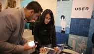 FILE PHOTO: Uber recruiter Lorena Castellanos talks to one Masood Noori at TechFair LA a technology job fair in Los Angeles (REUTERS / Lucy Nicholson) 