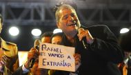 Ecuadoran presidential candidate of the ruling Alianza PAIS party, Lenin Moreno shows a sign that reads 