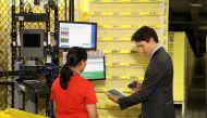 Canada Prime Minister Justin Trudeau scans merchandise with an employee during a tour of the Amazon Fulfillment Centre in Brampton, Ontario, Canada, October 20, 2016 (REUTERS / Fred Thornhill) 