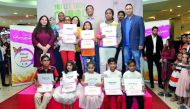 Santosh Pai, (fourth right), COO Landmark Group; Qatar, Rajgopal, (third left), Marketing Manager Landmark Group; and other officials with winners of Baby shop drawing competition ‘Expressions’ at Centerpoint Alasmakh Mall, yesterday. 
Pic Kammutty VP / 