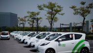 This picture taken on April 18, 2017 shows EV Card share cars parked at a station in Shanghai.  AFP / Johannes EISELE 