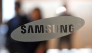 The logo of Samsung Electronics is seen on a glass door at the company's showroom in Seoul on April 27, 2017.  AFP / JUNG Yeon-Je
