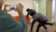 Graymatics employees pretend to fight as they record footage to be used to 