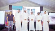 Salman bin Mohammed Al Muhannadi (third right), Barwa Group CEO, with other officials pose for a group photo after the press conference held at Madinat Al Mawater project yesterday. (Pic: Baher Amin/ The Peninsula)