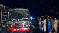 Indian recovery personnel douse a bus involved in a collision in Bareilly in Uttar Pradesh, yesterday.