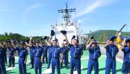 Japan Coast Guard members from the ship Echigo PLH08 wave to Vietnam Coast Guard members at the end of a joint training exercise in the sea off Vietnam's central city of Da Nang, yesterday.