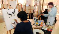 People take part in a drawing event at Gulf Mall. Pic: Abdul Basit / The Peninsula