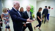 Senators John McCain and Bob Corker walk to a meeting of Republican senators to discuss a new version of their healthcare bill at the US Capitol in Washington, DC, yesterday.