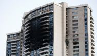 The charred exterior of the Marco Polo Building is pictured after a fire broke out on the upper floors in Honolulu, Hawaii, on July 14, 2017. At least three people were killed and a dozen injured when a massive fire tore through a 36-story apartment compl