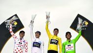 (From left) France’s Warren Barguil wearing the best climber’s polka dot jersey, Great Britain’s Simon Yates wearing the best young’s white jersey, Tour de France 2017’s winner Great Britain’s Christopher Froome, wearing the overall leader’s yellow jersey