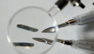 Tiny radio frequency identification (RFID) computer chips with the needles used to implant them under the skin are pictured in New York January 4, 2006. Reuters/Chip East