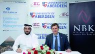 Sheikh Khalid Nawaf Al Thani (left), representing NBK & SNC–Lavalin, and Professor Richard Wells, Dean of transnational education representing AFG College, during the signing ceremony.  