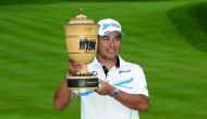 Hideki Matsuyama of Japan holds the trophy after winning the World Golf Championships - Bridgestone Invitational at Firestone Country Club South Course in Akron, Ohio on Sunday.
