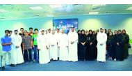 Senior Qatar Financial Centre representatives with 30 students from Bedaya as part of their summer camp for high school and university students.