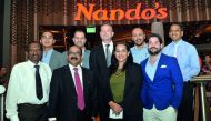 C V Rappai (second left in front row), CEO of Oryx Group for Food Services and Nando’s Qatar; Acting COO, Grant Ring (centre in back row); Branch Manager, Hani Ibrahim (second right in back row); Operation Manager, Steven Holloway (right in first row); Ma