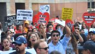 Young immigrants and supporters walk holding signs during a rally in support of Deferred Action for Childhood Arrivals (DACA) in Los Angeles, California on September 1, 2017.  AFP / FREDERIC J. BROWN
