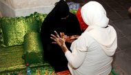 A visitor gets henna patterns applied during her visit to Souq Waqif Doha on the first day of Eid al Adha. Photos by: Qassim Rahmatullah © The Peninsula