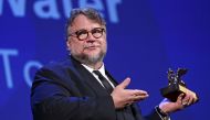 Director Guillermo Del Toro holds the Golden Lion award for the best movie 