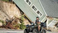 A sheriff's officer passes by a beachfront home destroyed by Hurricane Irma in Vilano Beach, Florida. (Sean Rayford/Getty Images/AFP).