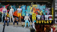 Men sitting outside a discount clothing retail store in Istanbul,  July 13, 2016 (Reuters / Murad Sezer) 