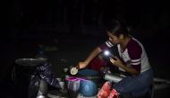 A woman prepares coffee in a square after a powerful quake hit Mexico City, late on September 19, 2017.  AFP / Ronaldo Schemidt