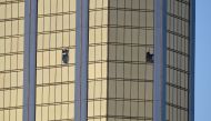 Broken windows are seen on the 32nd floor of the Mandalay Bay Resort and Casino after a lone gunman opened fired on the Route 91 Harvest country music festival on October 2, 2017 in Las Vegas, Nevada. David Becker/AFP
