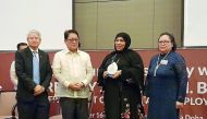 Philippine Labour and Employment Secretary Silvestre H Bello III (second left) with Qatari physician Dr Hanadi Al Hamad (second right)  after presenting a special award as Ambassador Alan L Timbayan (left) looks on.
