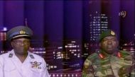 Zimbabwe Defence Forces Major-General SB Moyo (R) makes an announcement on state broadcaster ZBC, in this still image taken from a November 15, 2017 video. ZBC/Handout via REUTERS 