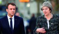 France's President Emmanuel Macron (L) and Britain's Prime minister Theresa May talk while walking to the luncheon during the European Social Summit in Gothenburg, Sweden, on November 17, 2017. AFP / Jonathan Nackstrand