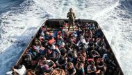 A Libyan coast guardsman stands on a boat during the rescue of 147 illegal immigrants attempting to reach Europe off the coastal town of Zawiyah, 45 kilometres west of the capital Tripoli, on June 27, 2017.  AFP / Taha JAWASHI