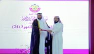 Minister of Awqaf and Islamic Affairs H E Dr Ghaith bin Mubarak Al Kuwari honouring one of the winners.