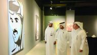 Qatari artist Ahmed Al Maadheed (centre) and Katara Deputy General Manager and Head of Operations Ahmad Al Sayed (right) tour the exhibition at Katara Building 18 yesterday. Pic: Raynald C Rivera / The Peninsula