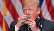 US President Donald Trump takes a sip of water while speaking on his national security strategy at the Ronald Reagan Building in Washington, DC on December 18, 2017. / AFP / MANDEL NGAN