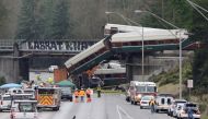 Rescue personnel and equipment are seen at the scene where an Amtrak passenger train derailed on a bridge over interstate highway I-5 in DuPont, Washington, U.S. December 18, 2017. REUTERS/Steve Dipaola.