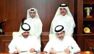 The Minister of Municipality and Environment, H E Mohamed bin Abdullah Al Rumaihi (right),  and Minister of Administrative Development, Labour and Social Affairs H E Dr Issa bin Saad Al Jafali Al Nuaimi ((left) witnessing the signing ceremony at the headq
