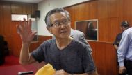 A file photo of Peru's former President Alberto Fujimori waves to the media as he arrives in court for the sentencing in his trial in Lima January 8, 2015. REUTERS/Enrique Castro-Mendivil/File Photo