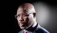 (FILES) This file photo taken on September 25, 2017, shows former football player and candidate in Liberia's presidential elections, George Weah as he poses during a photo session in Paris.   / AFP / JOEL SAGET