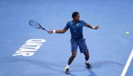 France's Gael Monfils returns the ball to Italy's Paolo Lorenzi during the first round of the ATP Qatar Open tennis competition in Doha on January 2, 2018. / AFP / KARIM JAAFAR
