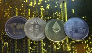 Representations of the Ripple, Bitcoin, Etherum and Litecoin virtual currencies are seen on a PC motherboard in this illustration picture, February 14, 2018. REUTERS/Dado Ruvic/Illustration