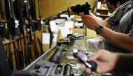 Customers look over the last two AR-15 style rifles for sale inside the Bullet Hole gun shop in Sarasota, Florida (Reuters) 