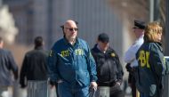 FBI officers are seen outside the White House as several blocks are closed down by the United States Secret Service on March 3, 2018 in Washington, DC. / AFP / Alex Edelman 