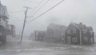 Coastal areas in New England are bracing for the high tide that is scheduled to be at it's highest as waves crash into homes in Scituate, Massachusetts on March 2, 2018.  AFP / RYAN MCBRIDE
