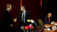 CEO Patrik Gisel (R) of Switzerland's third-largest bank Raiffeisen, looks on as interim chairman Pascal Gantenbein (C) and re-signed chairman Johannes Rueegg-Stuerm shake hands during a news conference in Zurich, Switzerland March 9, 2018. Reuters/Arnd W