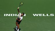 Roger Federer of Switzerland serves to Borna Coric of Croatia during the semifinal match at BNP Paribas Open - Day 13 on March 17, 2018, in Indian Wells, California. Joe Scarnici/Getty Images/AFP
