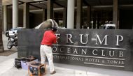 A worker removes the Trump name from the Trump Ocean Club International Hotel and Tower in Panama City, Panama March 5, 2018. Reuters/Carlos Lemos