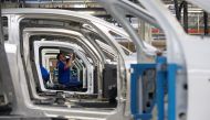 An employee works on the automobile assembly line of Bluecar electric city cars at Renault car maker factory in Dieppe, western France, September 1, 2015. Reuters/Philippe Wojazer